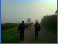 8.54 a.m. Walking up the lane away from Waltham in the early morning mist. You will note that both Peter and Larry are wearing their stylish headgear .